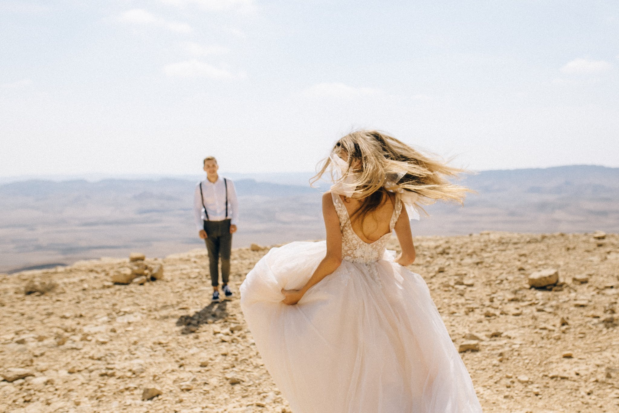 A Couple in The Desert Wearing Wedding Clothes